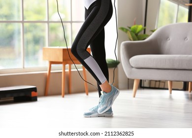 Sporty Young Woman Jumping Rope At Home