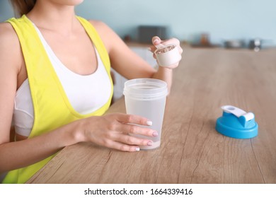 Sporty Young Woman Making Protein Shake At Home