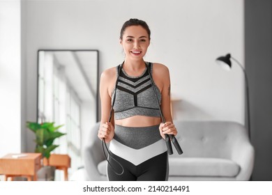 Sporty Young Woman With Skipping Rope At Home