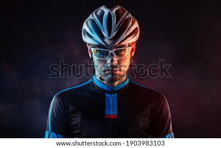 Spost background with copyspace. Cyclist. Dramatic colorful close-up portrait.