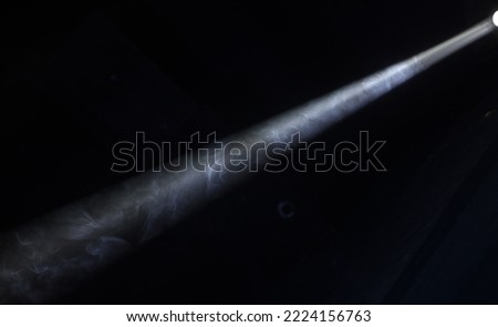 a spotlight beam on a dark theater stage