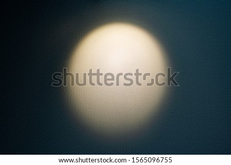 A spotlight  illuminating a wall.