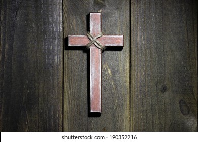 Spotlight On Hanging Wooden Cross On Old Rustic Antique Wood Background; Easter, Christmas, Memorial Day And Religious Background With Copy Space