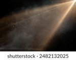 spotlight on stage or gods rays with particles isolated on black background	