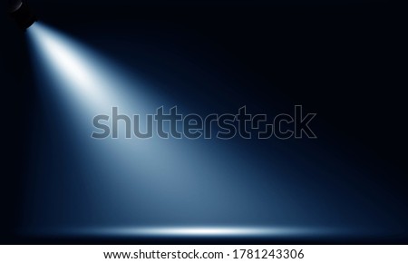 Spotlights illuminate empty stage blue background.