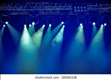 Spotlights and illumination equipment with fog on stage background - Shutterstock ID 185042138