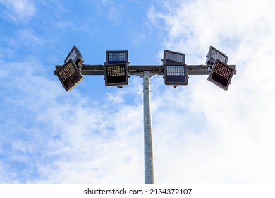 Spotlights On Steel Pole In Stadium With Blue Sky Background.