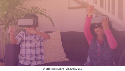 Spots of light against african american brother and sister wearing vr headset at home. national siblings day awareness concept - Powered by Shutterstock