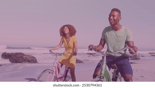 Spots of light against african american couple riding bicycles together at the beach. pedal day awareness concept - Powered by Shutterstock