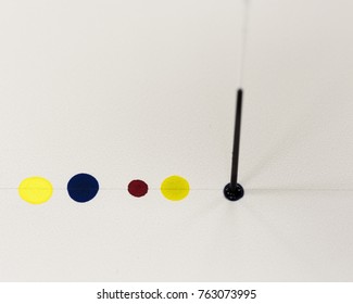 Spotting colored solutions an a thin layer chromatography plate
