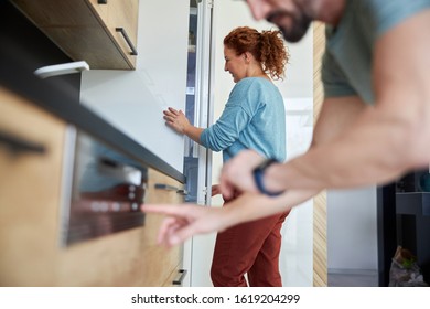 Spouces Are Doing Household Chores Using Home Appliances