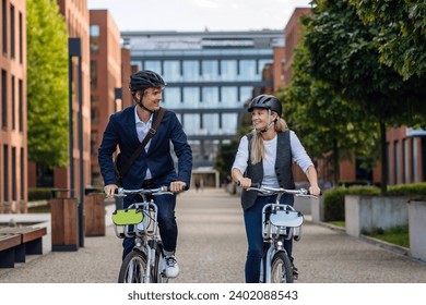 Spouses commuting through the city, riding bike on street. Middle-aged city commuters traveling from work by bike after a long workday. - Powered by Shutterstock