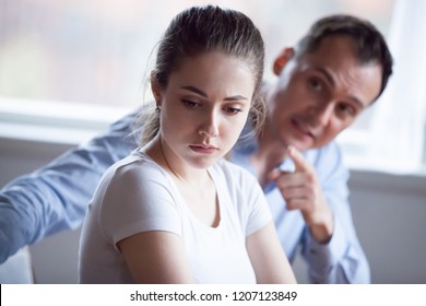 Spouses quarreling at home, frustrated wife listen claims from angry husband, focus of female. Head shot married couple have bad difficult relations. Break up unexpected pregnancy and divorce concept