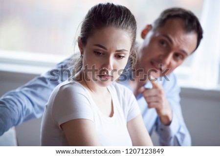 Spouses quarreling at home, frustrated wife listen claims from angry husband, focus of female. Head shot married couple have bad difficult relations. Break up unexpected pregnancy and divorce concept Stock photo © 