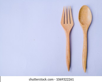 Sppon and fork kitchen utensils set handmade from coconut tree and bamboo wooden on isolated white background.