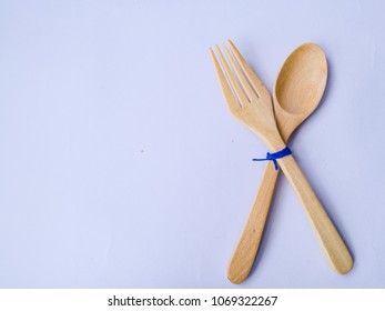 Sppon and fork kitchen utensils set handmade from coconut tree and bamboo wooden on isolated white background.