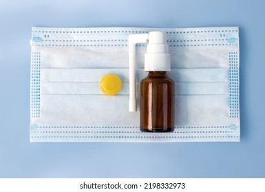 Spray And Lozenge Pill Tablet Candy Lemon Honey Ingredients Isolated On Surgical Protection Mask.anti Inflammatory Redness And Pain Treatment.isolated Blue Background.bacteria Virus