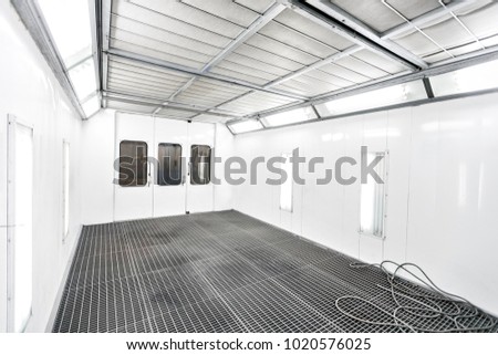 Spray paint cabinet in a car repair station. Auto service concept. High-quality painting of vehicles in a room with a filter and good light