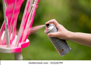 Spray Painting An Old Chair In The Color Pink 