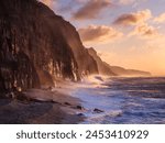 Spray from a storm blows up the cliffs at dawn in the seaside town of Sidmouth, Devon, England, United Kingdom, Europe