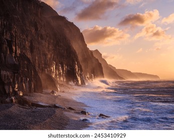 Spray from a storm blows up the cliffs at dawn in the seaside town of Sidmouth, Devon, England, United Kingdom, Europe - Powered by Shutterstock