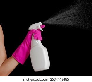 Spraying cleaning agent on black background. Hand in pink glove with bottle. Professional cleaning - Powered by Shutterstock