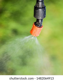 Spraying Herbicide From The Nozzle Of The Sprayer Manual. Devices For Processing Plants In The Garden.