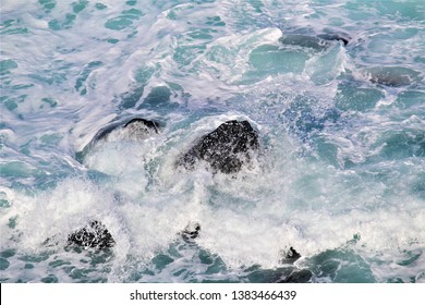 Spraying Wave Crashing Over Rocks At Penguin Parade, Australia