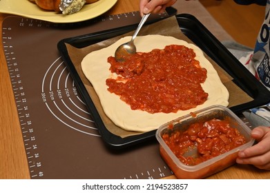 Spread Tomato Sauce On The Pizza Dough