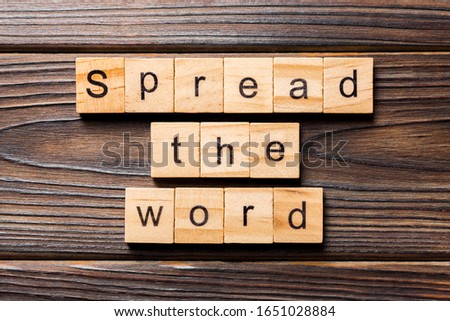 Spread the word word written on wood block. Spread the word text on table, concept.
