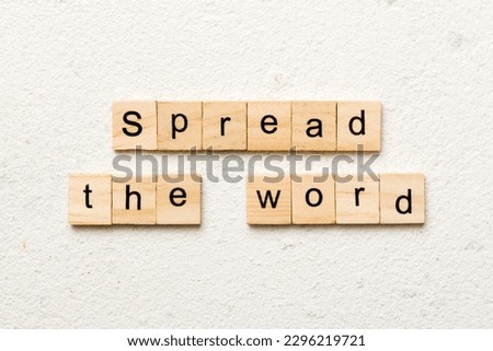 Spread the word word written on wood block. Spread the word text on table, concept.