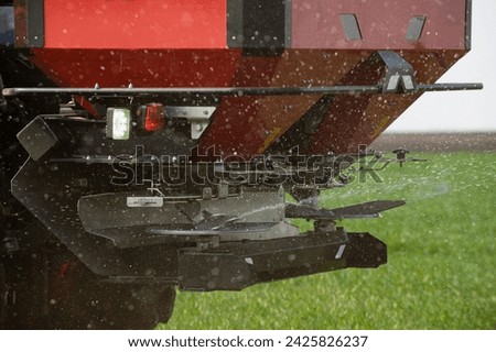 Spreading artificial fertilizers in wheat field. Transport, agricultural.