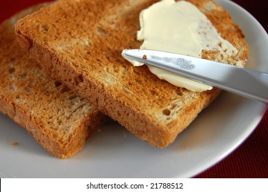 Spreading Butter With A Knife On A Hot Fresh Toast