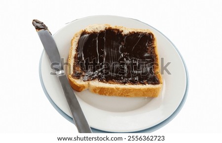 Spreading the iconic Australian spread vegemite on to a slice of fresh bread.