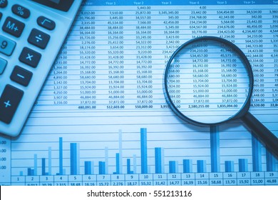 Spreadsheet bank accounts accounting with calculator and magnifying glass. Concept for financial fraud investigation, audit and analysis.