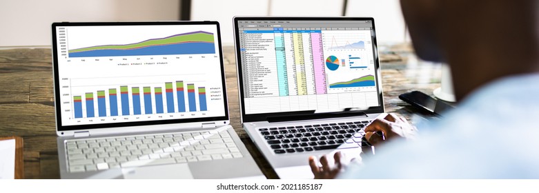 Spreadsheet Data Analyst Employee Using Multiple Computer Screens