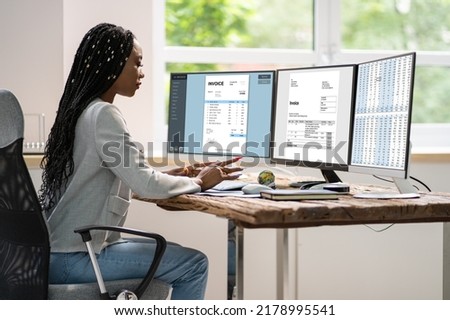 Spreadsheet And Electronic Invoice On Multiple Computer Screens