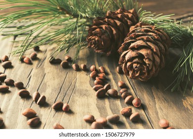 Sprig Of Pine, Pine Cones And Nuts On A Wooden Table