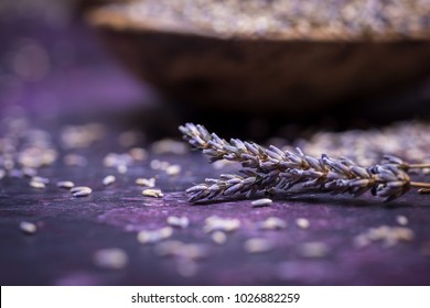 Sprigs Of Lavendar And Scattered Flowers With A Bowl Of Dried Lavender In The Background. Selective Focus With Bokeh. 