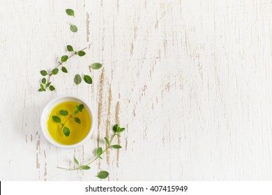 Sprigs of thyme and olive oil on a white Shabby background, space for text - Shutterstock ID 407415949