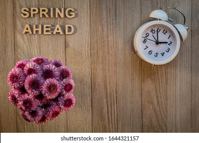 Spring Ahead Daylight Saving Time Concept With Pink Chrysanthemums And Clock On Wood Background Flat Lay 