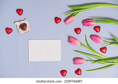 spring background with tulips and heart shaped chocolates for mother's day, women's day or valentine's day