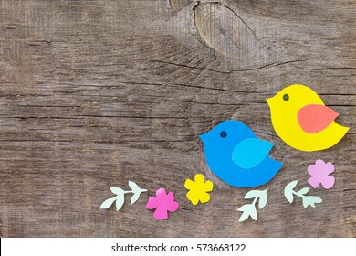 Spring Background. Two Birds And Spring Flowers On A Wooden Background. Craft For Kids. Copy Space. Children's Art Project, Needlework, Crafts For Children.