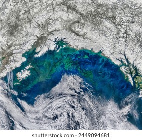 A Spring Bloom in the Gulf of Alaska. The tiny, plantlike organisms thrive on iron that seeps into the ocean. Elements of this image furnished by NASA.