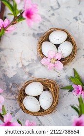 Spring blossom, Easter concept, miniature bunny, flowering tree close-up and copy space. Pink natural texture of natural flowering tree. Easter egg and branches of blossoming on an table. - Shutterstock ID 2122738664