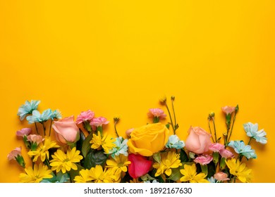 Spring blossom. Floral wreath on yellow background. For easter and spring greeting cards with copy space. Springtime. Flat lay, top view.