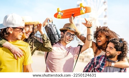 Spring break life style concept with millenial friends having fun together at summer festival by ferris wheel - Happy guys and girls students cheering at holiday vacation days  - Bright warm filter
