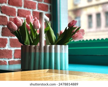 Spring Charm: Pink Tulips in a Rustic Container. Cozy Cafe Corner with Fresh Flowers and Vibrant Colors. Indoor - Powered by Shutterstock