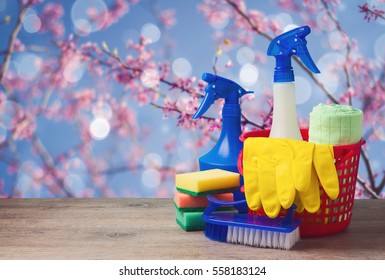 Spring cleaning concept with supplies over floral background