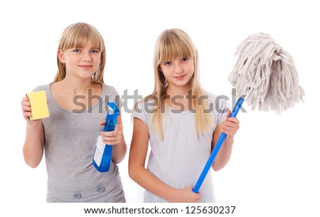 Spring cleaning - Sisters showing cleaning utensils isolated on white